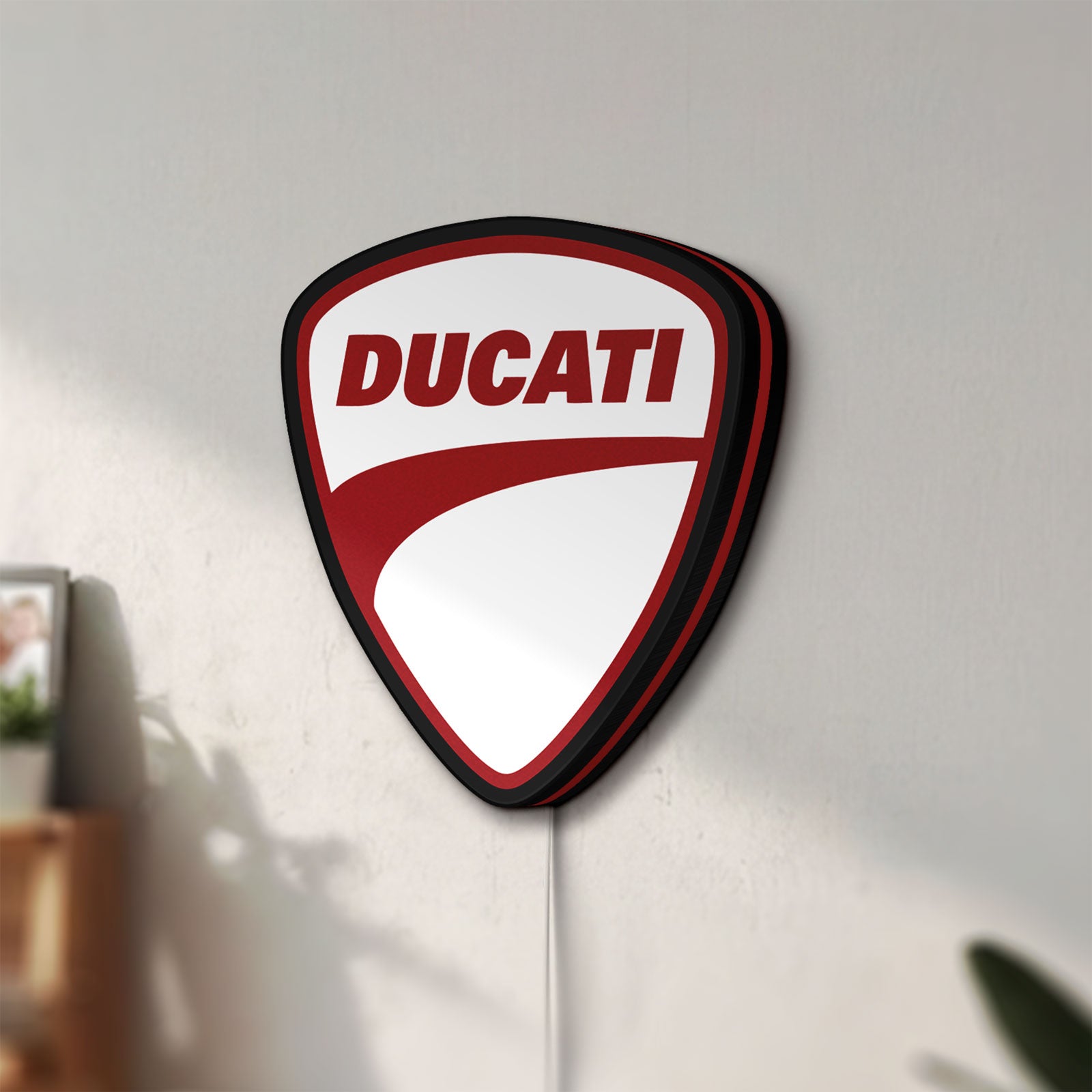 Unlit Ducati LED lightbox mounted on a wall in daylight