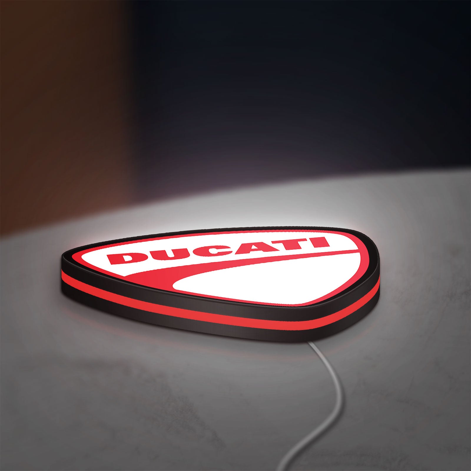Ducati LED lightbox lying flat on a desk with red glow
