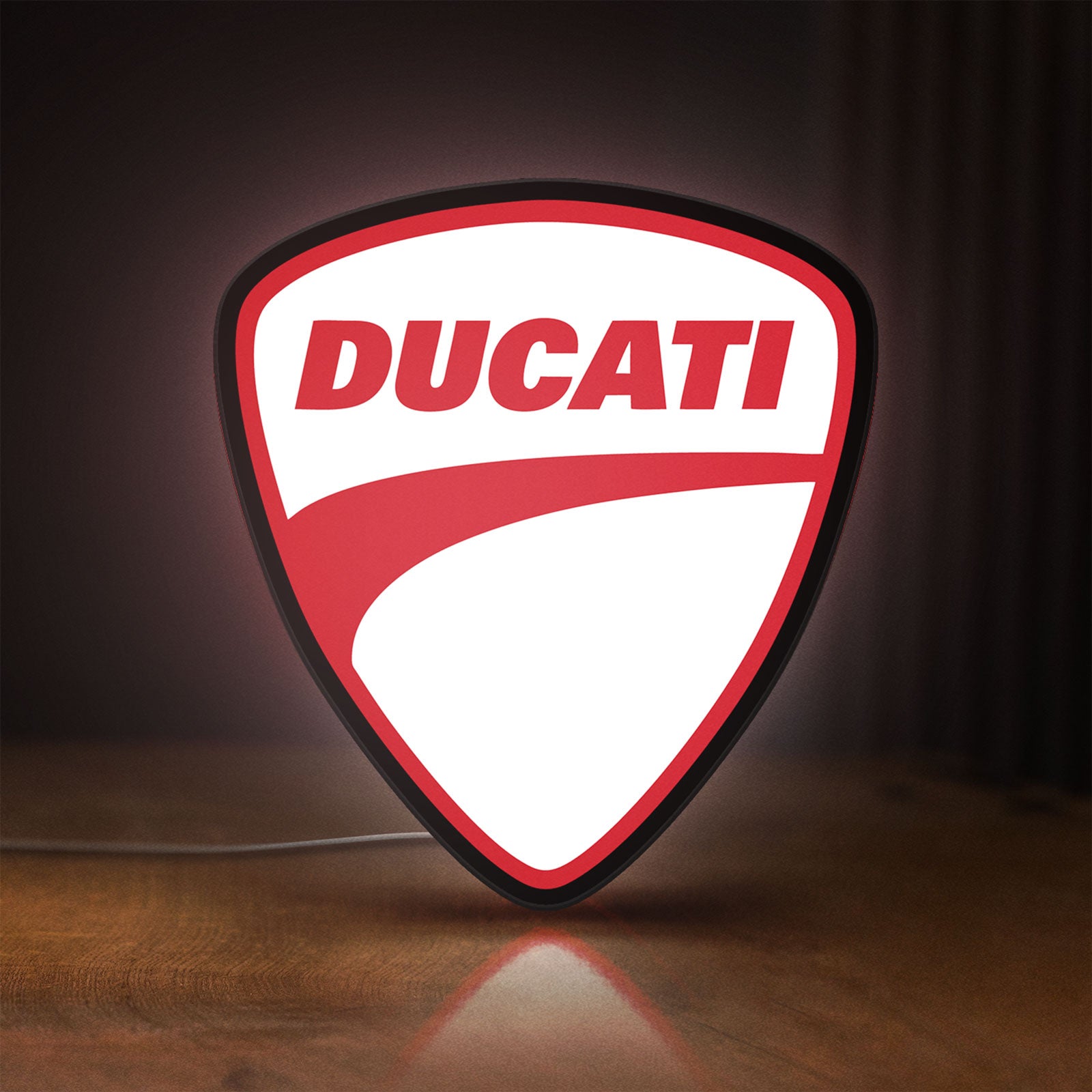Front view of Ducati LED lightbox sign glowing on a wooden desk
