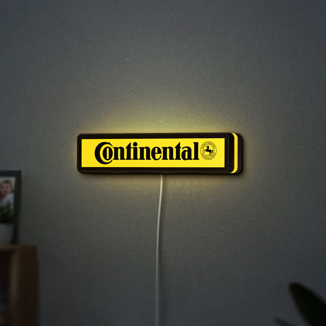 Continental LED lightbox hanging on a wall with yellow glow