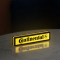 Continental LED lightbox standing on a desk from an angled side view with yellow glow