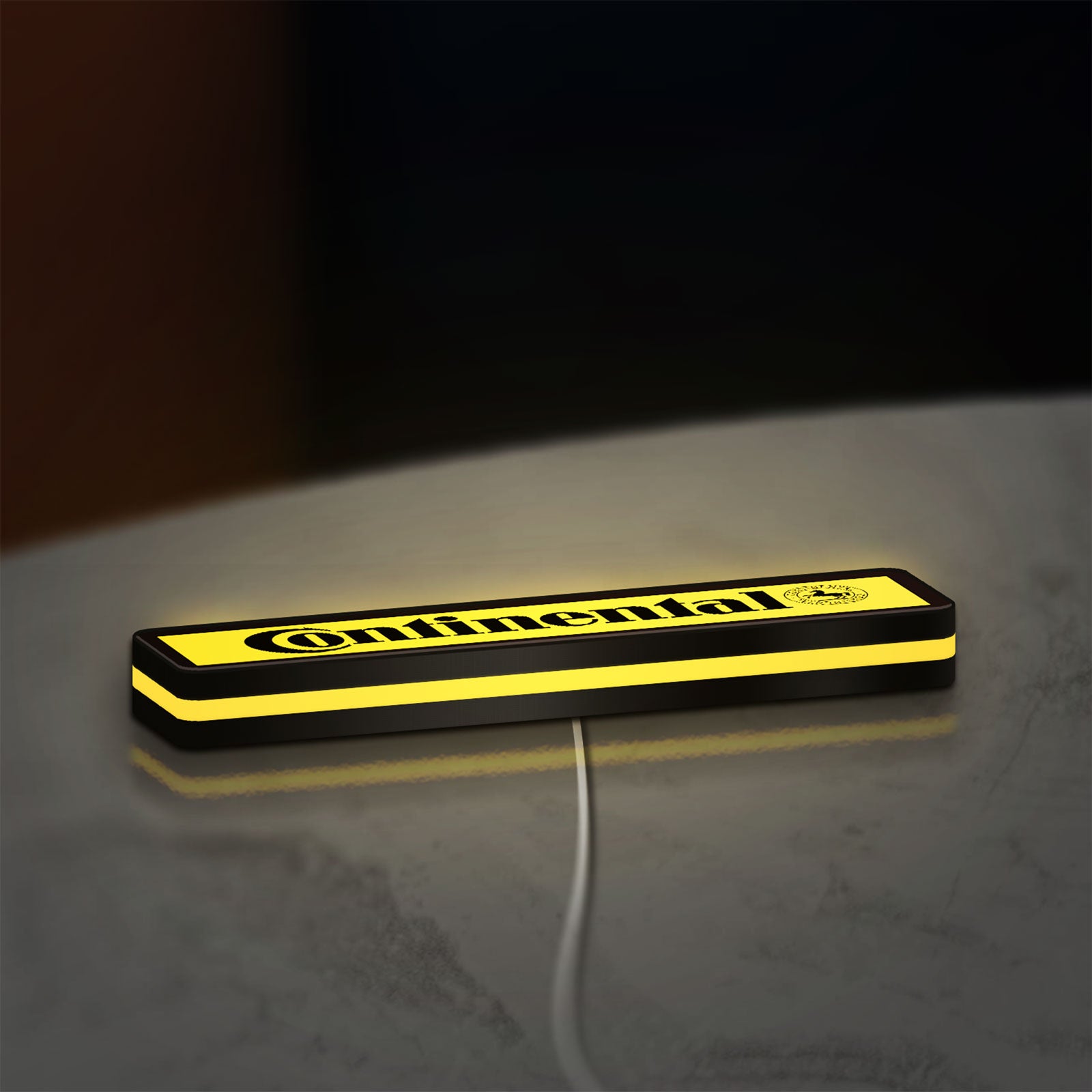 Continental LED lightbox lying flat on a desk with yellow glow