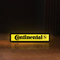 Front view of Continental LED lightbox sign glowing on a wooden desk