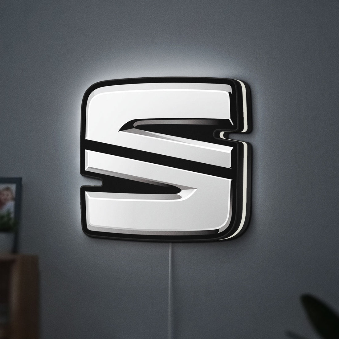 Seat LED lightbox hanging on a wall with white glow