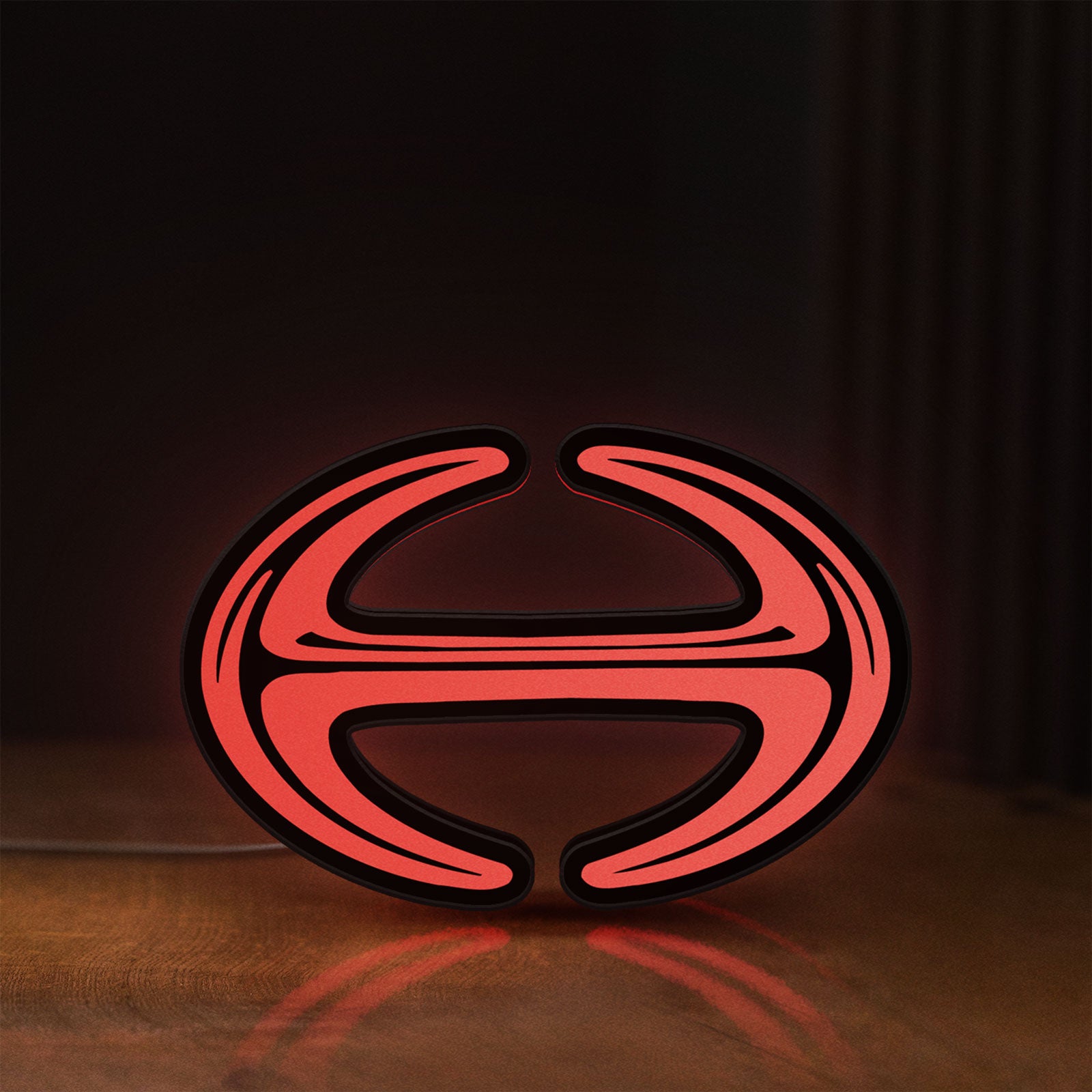 Front view of Hino Diesel Trucks LED lightbox sign glowing on a wooden desk