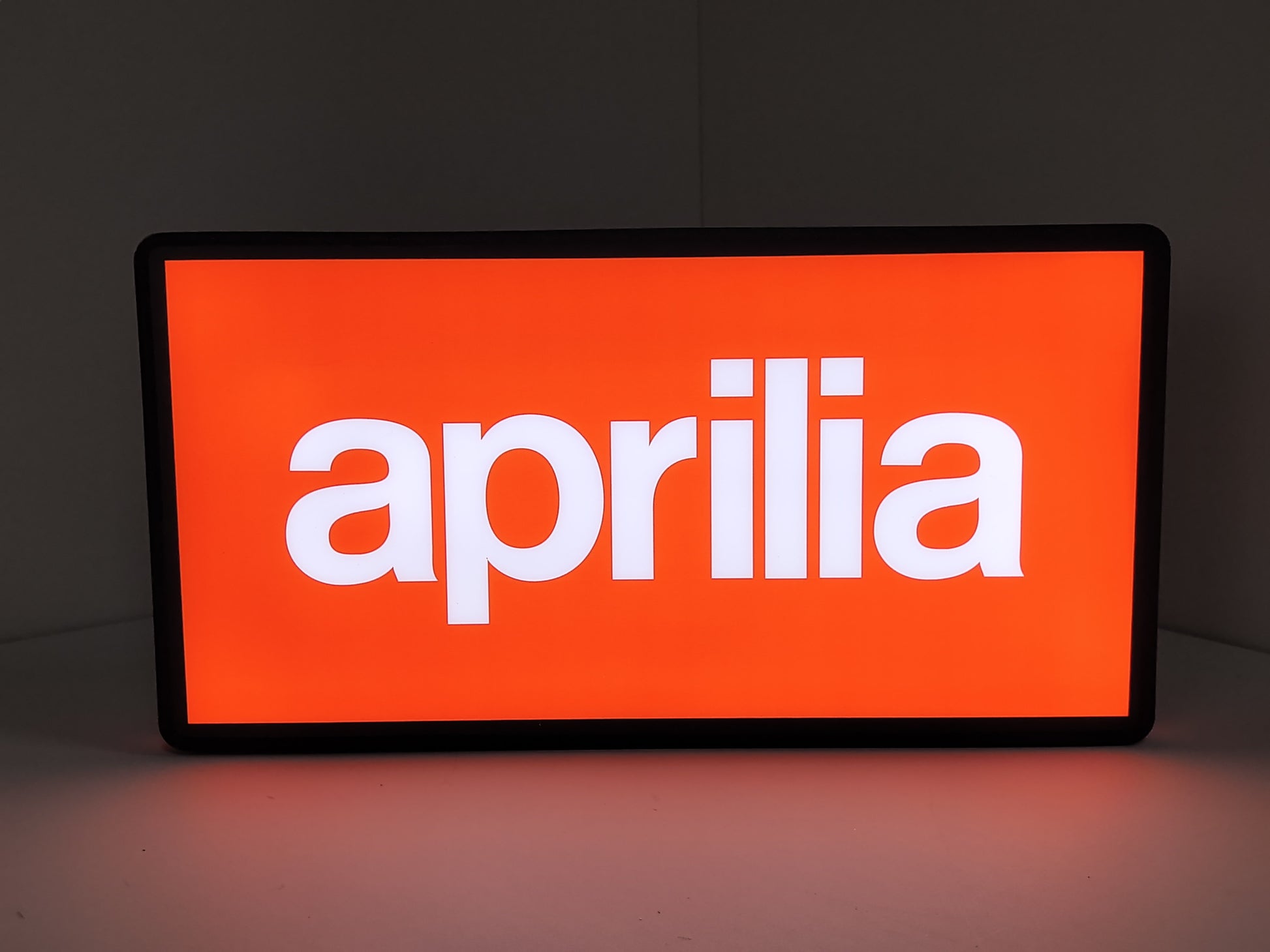 Illuminated front view standing of Aprilia Dimmable 3D LED Sign in 30cm, unique wall art for desk and room decor