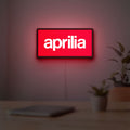 Aprilia LED lightbox hanging on a room wall with soft red light