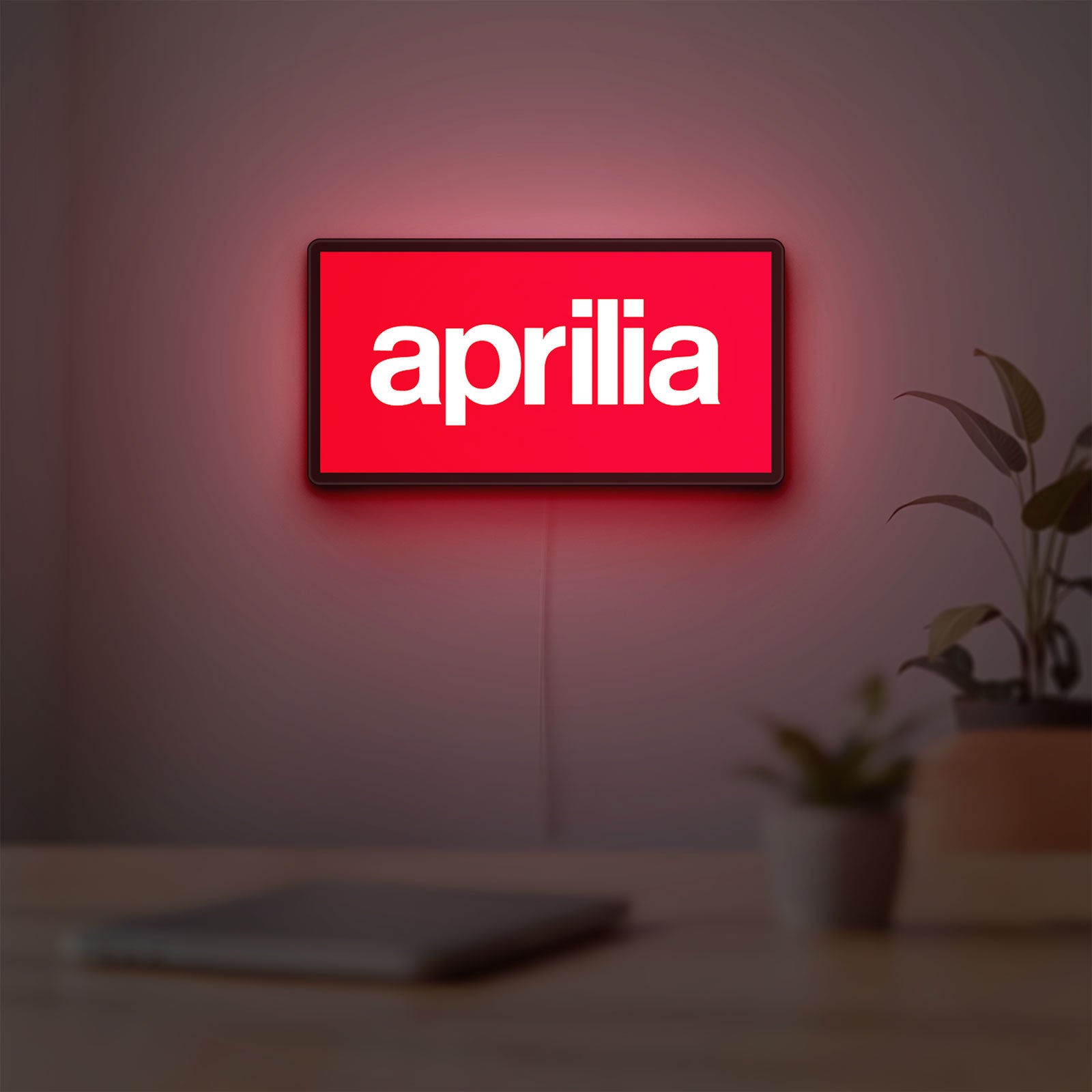 Aprilia LED lightbox hanging on a room wall with soft red light