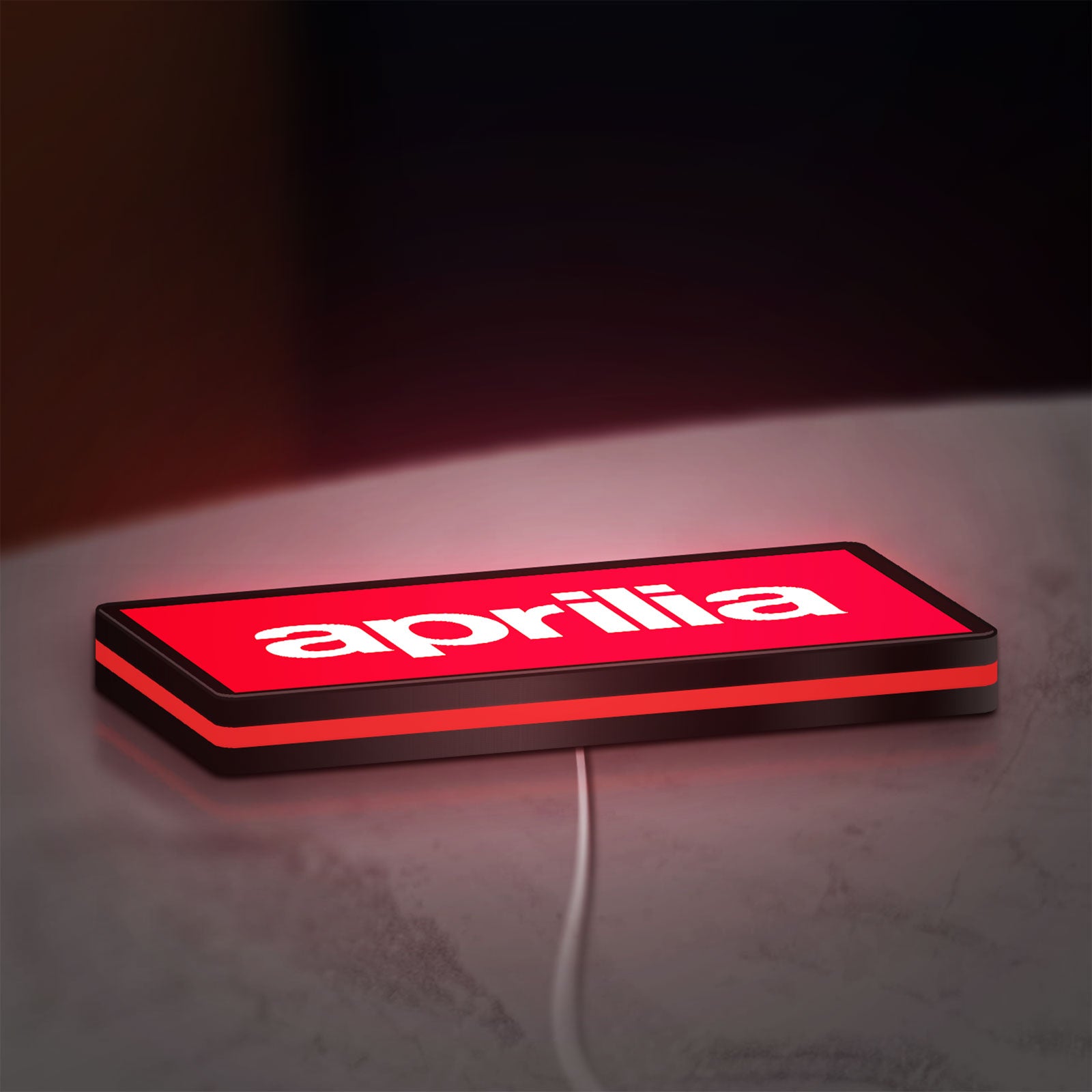 Aprilia LED lightbox lying flat on a desk with red glow
