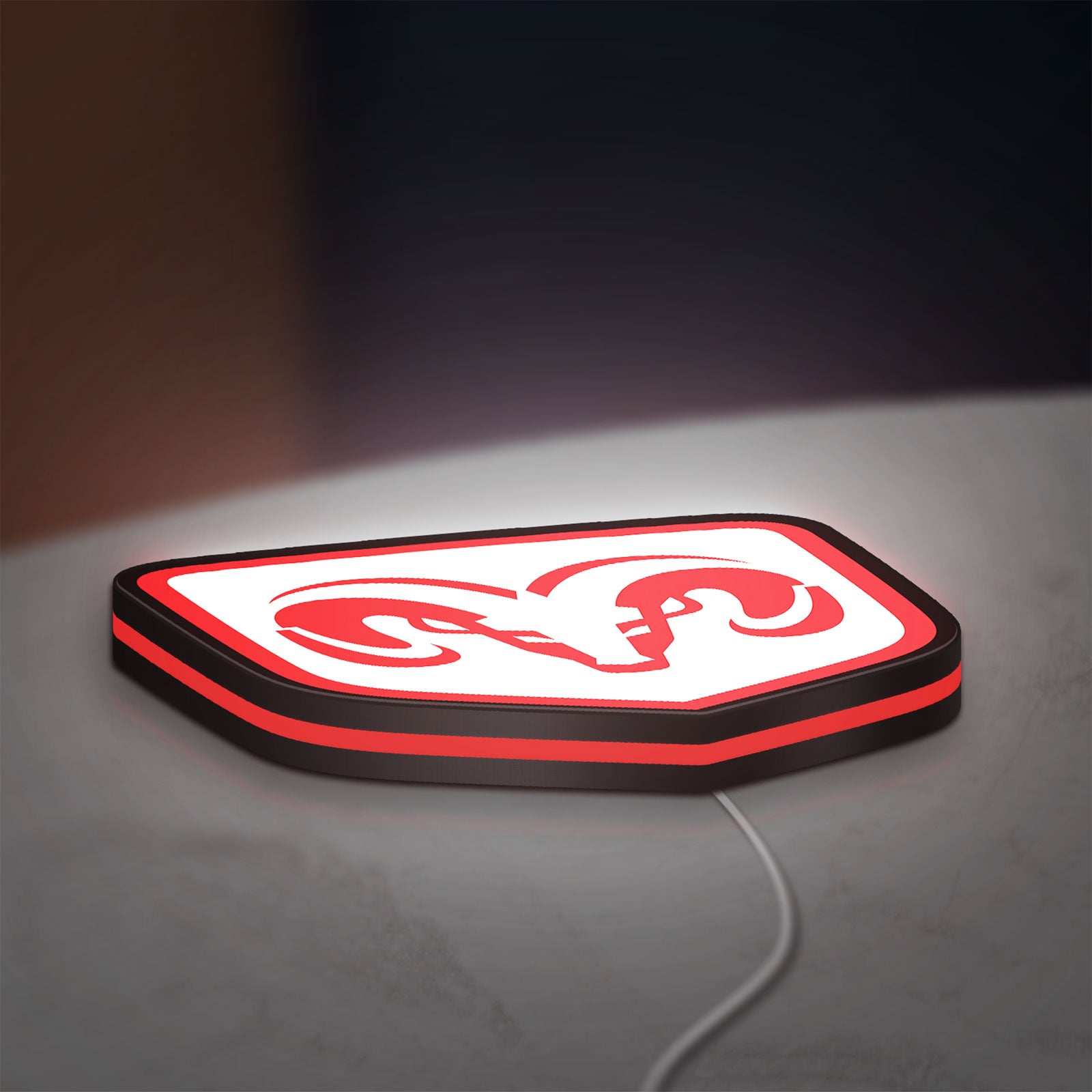 Dodge LED lightbox lying flat on a desk with red glow