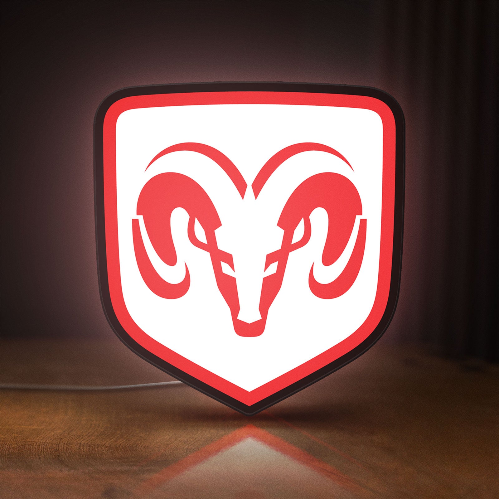 Front view of Dodge LED lightbox sign glowing on a wooden desk