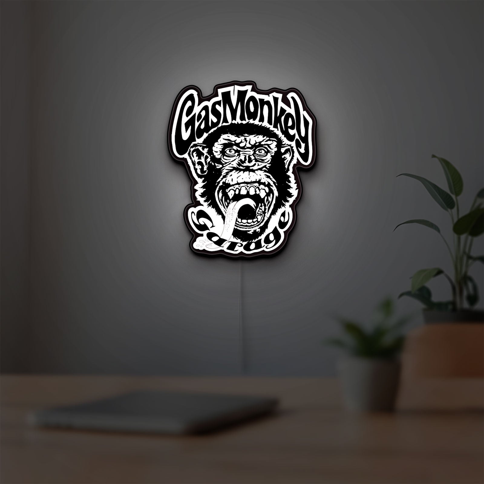 Gas Monkey Garage LED lightbox hanging on a room wall with soft white light
