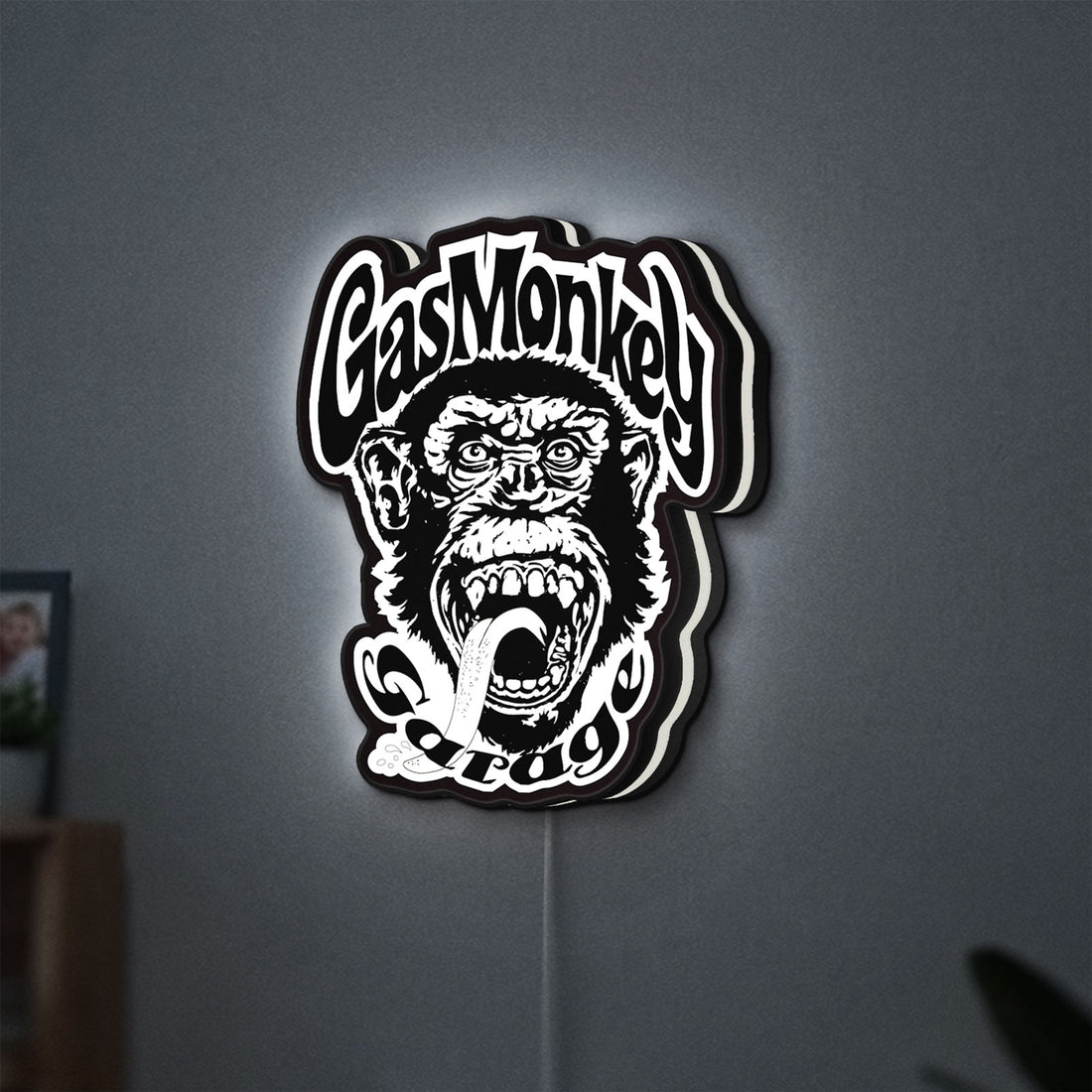 Gas Monkey Garage LED lightbox hanging on a wall with white glow