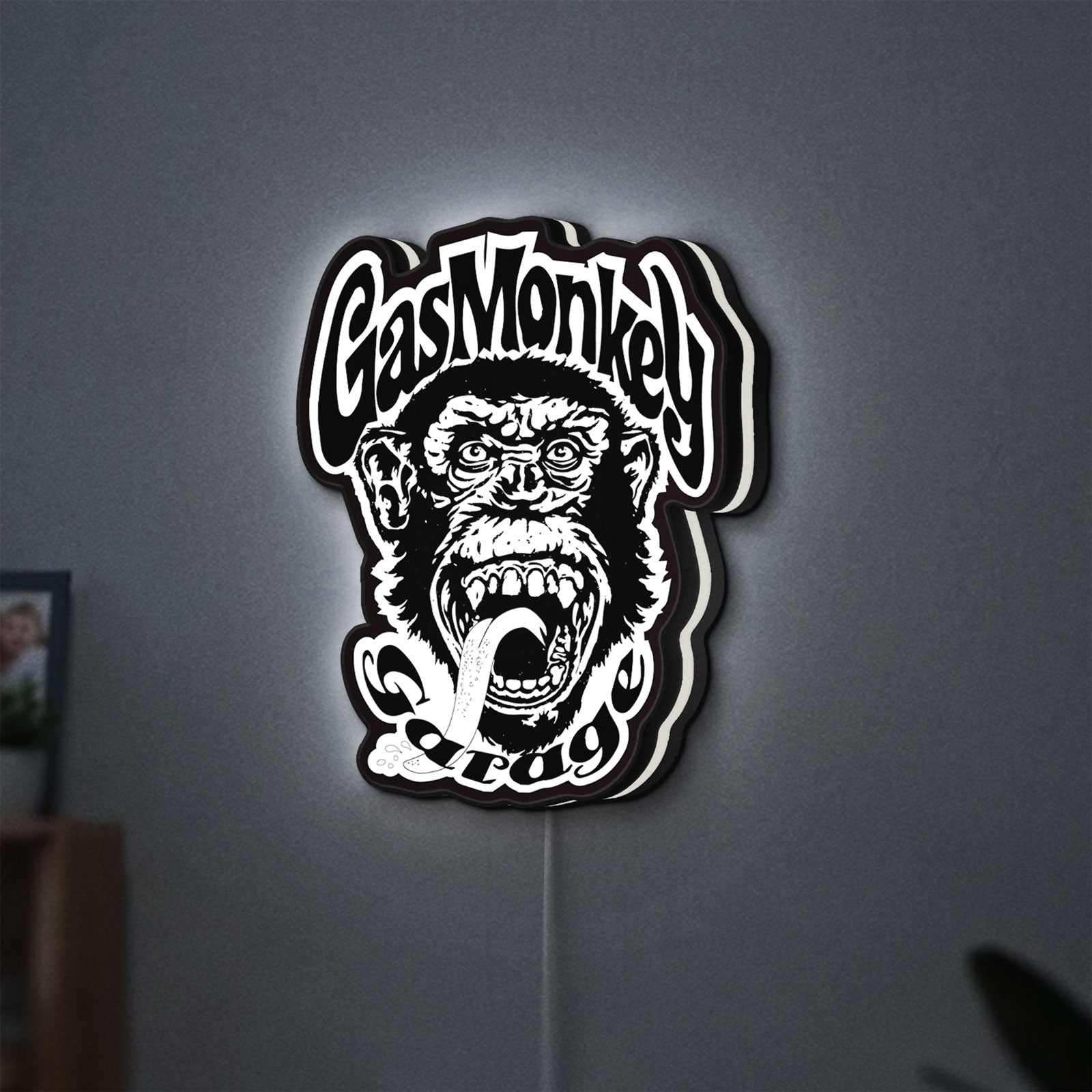 Gas Monkey Garage LED lightbox hanging on a wall with white glow
