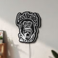 Unlit Gas Monkey Garage LED lightbox mounted on a wall in daylight