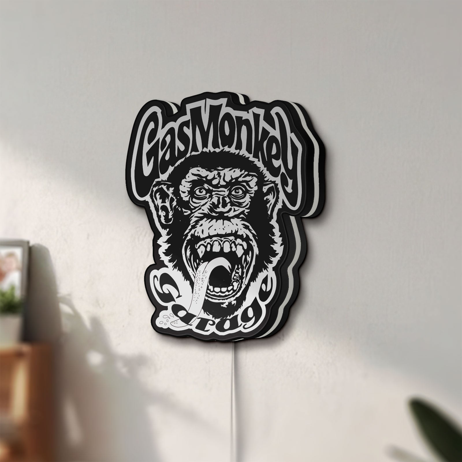 Unlit Gas Monkey Garage LED lightbox mounted on a wall in daylight