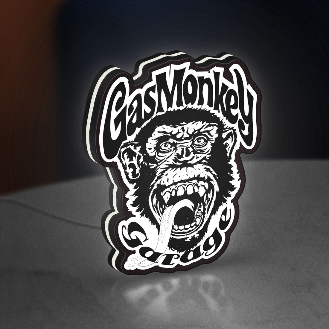 Gas Monkey Garage LED lightbox hanging on a wall with white glow