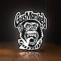 Front view of Gas Monkey Garage LED lightbox sign glowing on a wooden desk