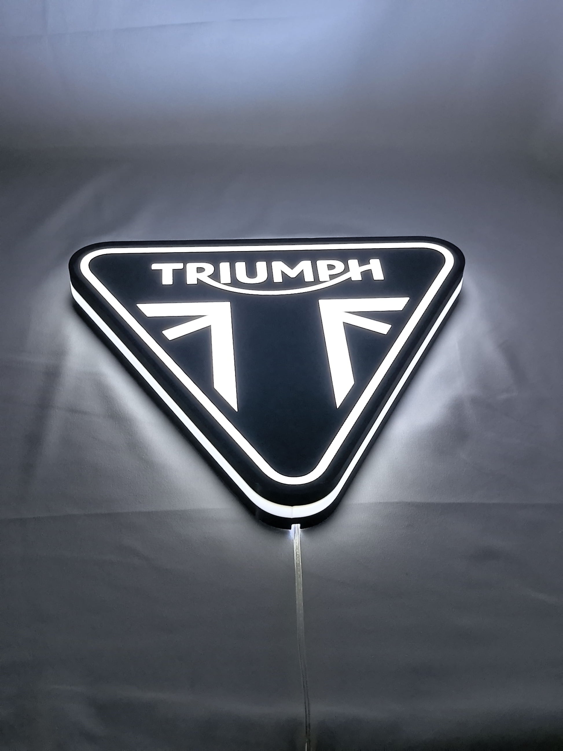 Triumph Motorcycles LED Sign (30cm) - Illuminated flat lay angled view, perfect for garage and man cave decor