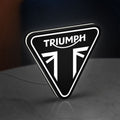 Triumph Motorcycles LED lightbox standing on a desk from an angled side view with white glow