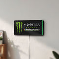 Unlit Monster Energy NASCAR Cup Series LED lightbox mounted on a wall in daylight