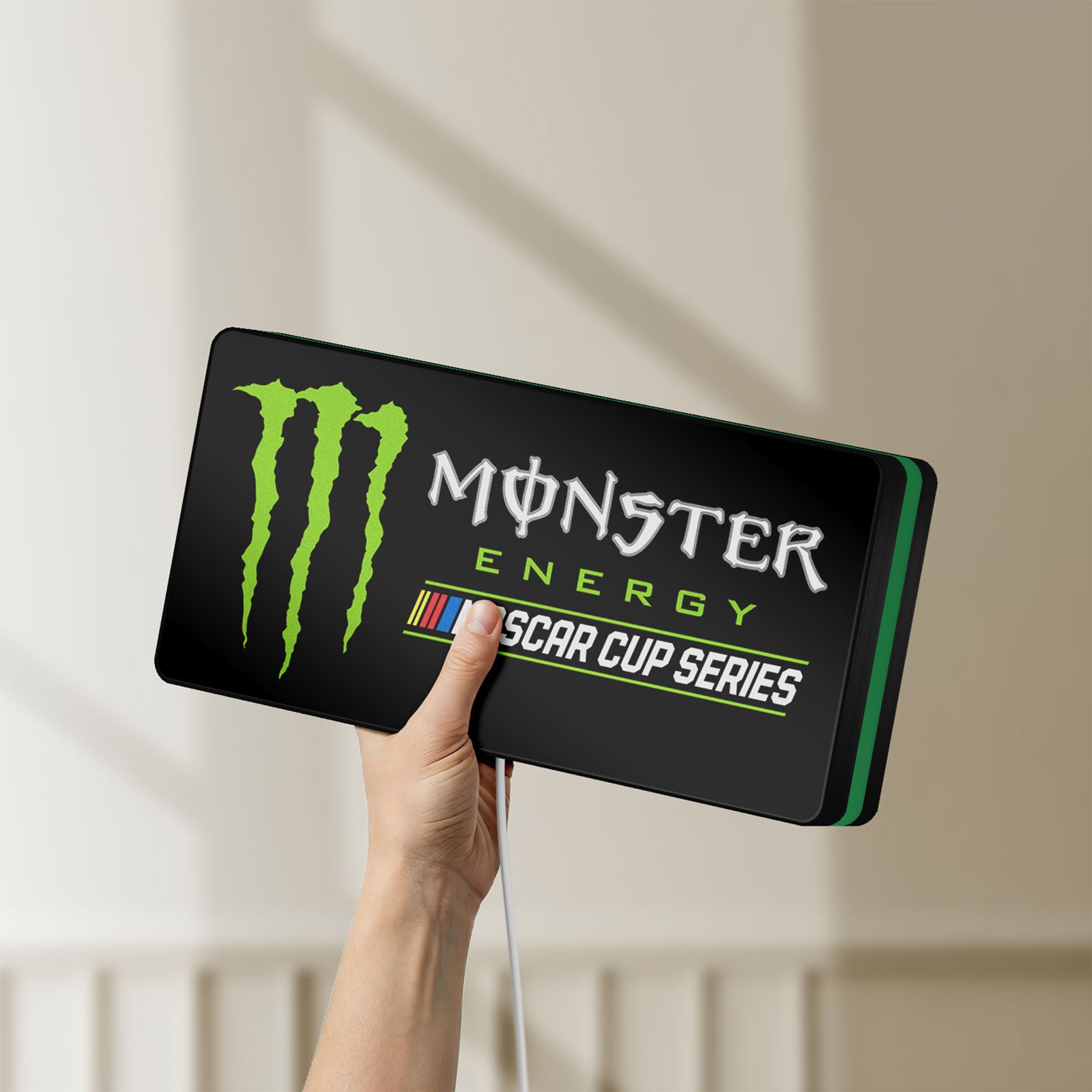 Unlit Monster Energy NASCAR Cup Series LED lightbox held by hand to show size and details
