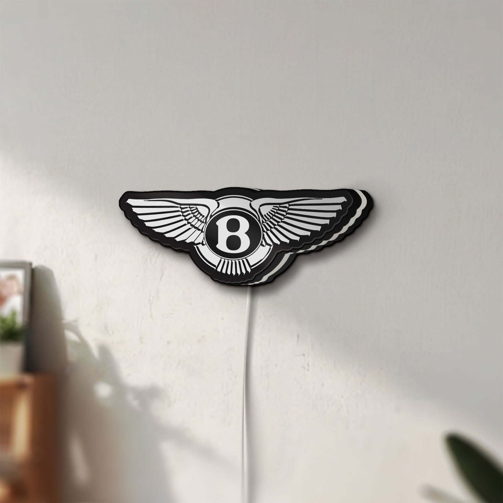 Unlit Bentley Motors LED lightbox mounted on a wall in daylight