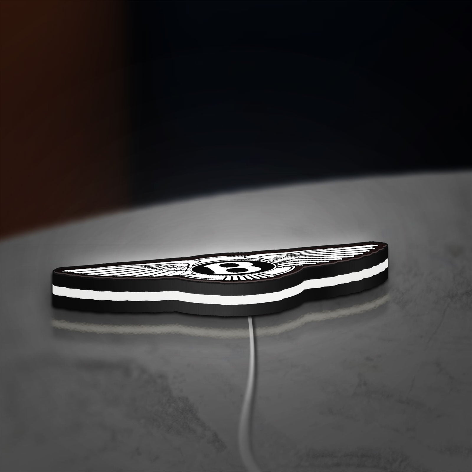 Bentley Motors LED lightbox lying flat on a desk with white glow
