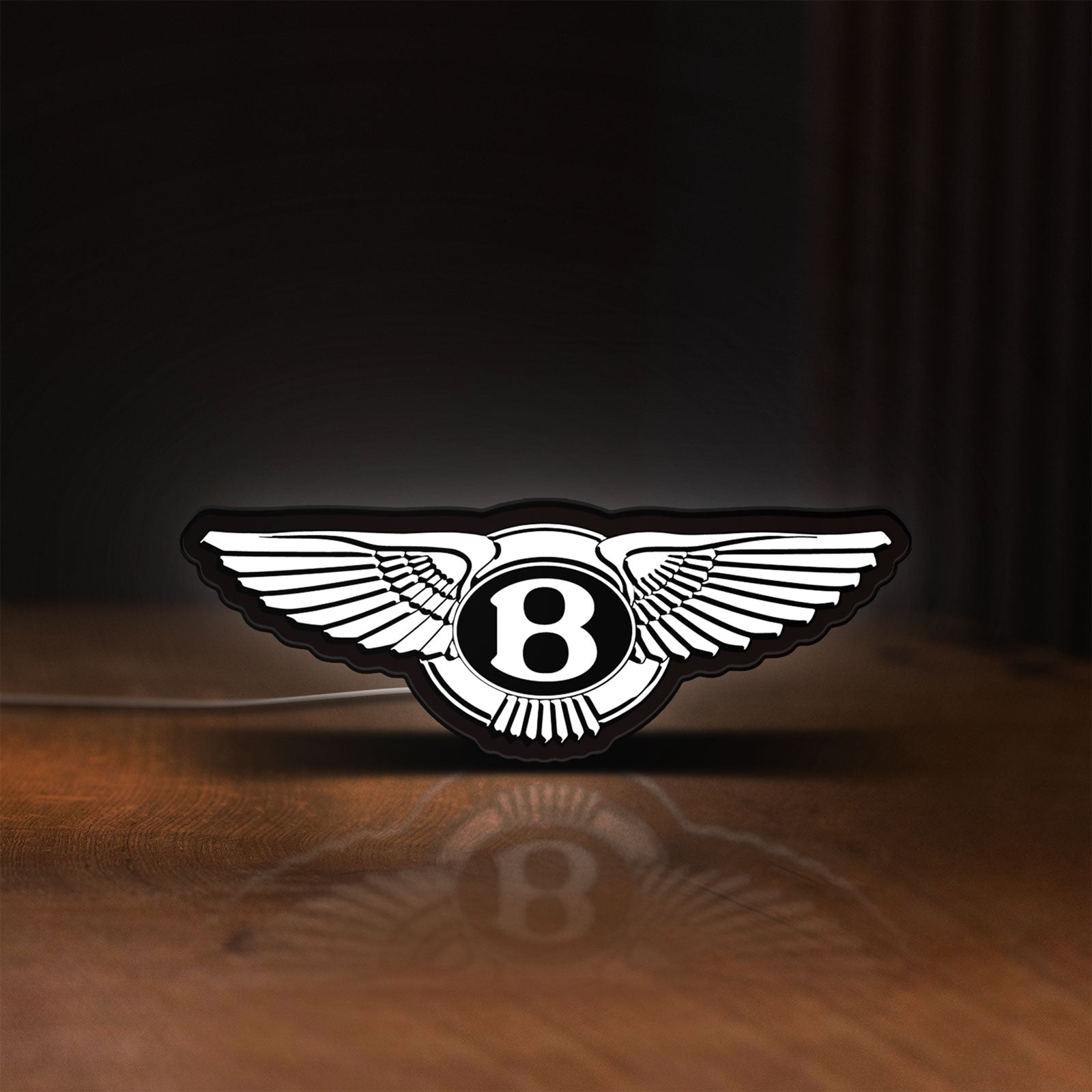 Front view of Bentley Motors LED lightbox sign glowing on a wooden desk