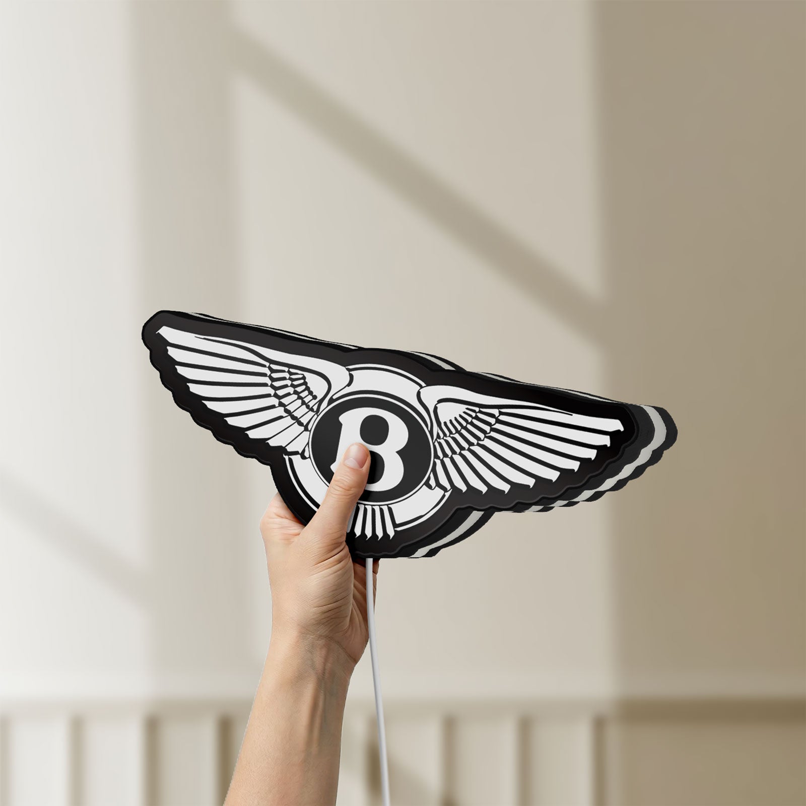 Unlit Bentley Motors LED lightbox held by hand to show size and details