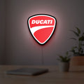 Ducati Sign LED lightbox hanging on a room wall with soft red light