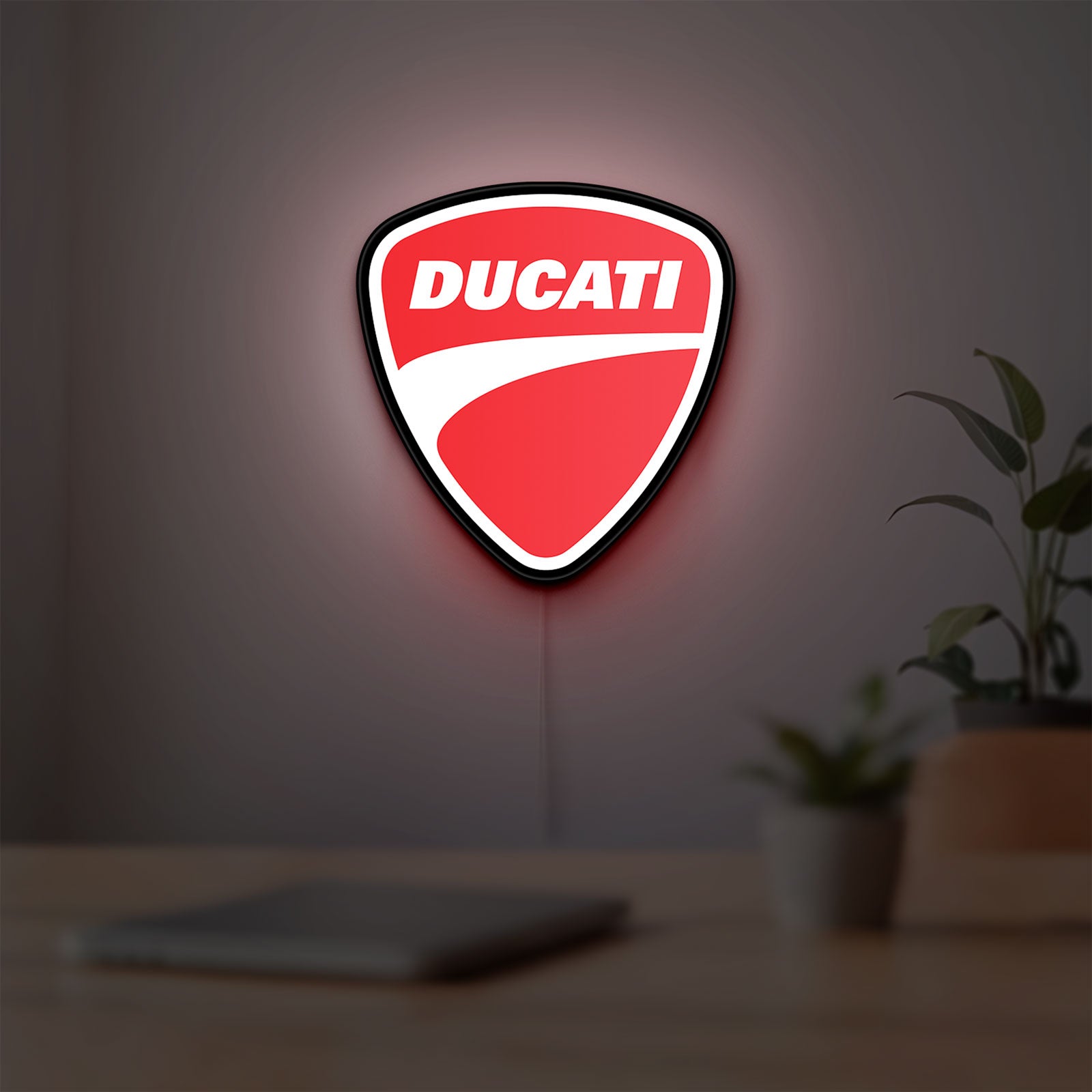 Ducati Sign LED lightbox hanging on a room wall with soft red light