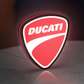 Ducati Sign LED lightbox standing on a desk from an angled side view with red glow