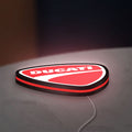 Ducati Sign LED lightbox lying flat on a desk with red glow