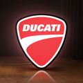 Front view of Ducati Sign LED lightbox sign glowing on a wooden desk