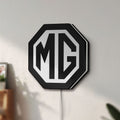 Unlit MG Car Logo LED lightbox mounted on a wall in daylight