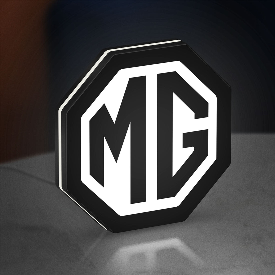 MG Car Logo LED lightbox hanging on a wall with white glow