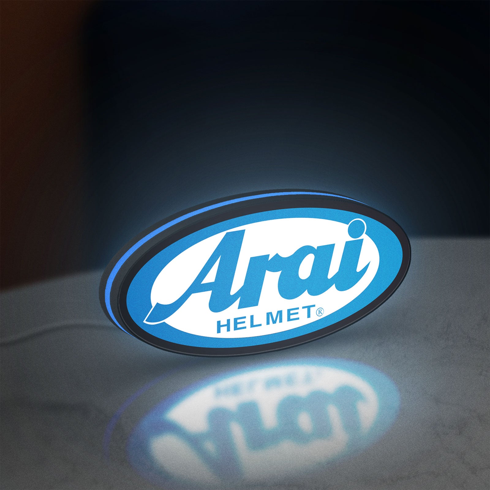 Arai Helmet LED lightbox standing on a desk from an angled side view with blue glow