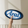 Unlit Arai Helmet LED lightbox held by hand to show size and details
