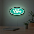 Land Rover LED lightbox hanging on a room wall with soft green light
