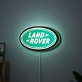 Land Rover LED lightbox hanging on a wall with green glow