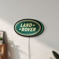 Unlit Land Rover LED lightbox mounted on a wall in daylight