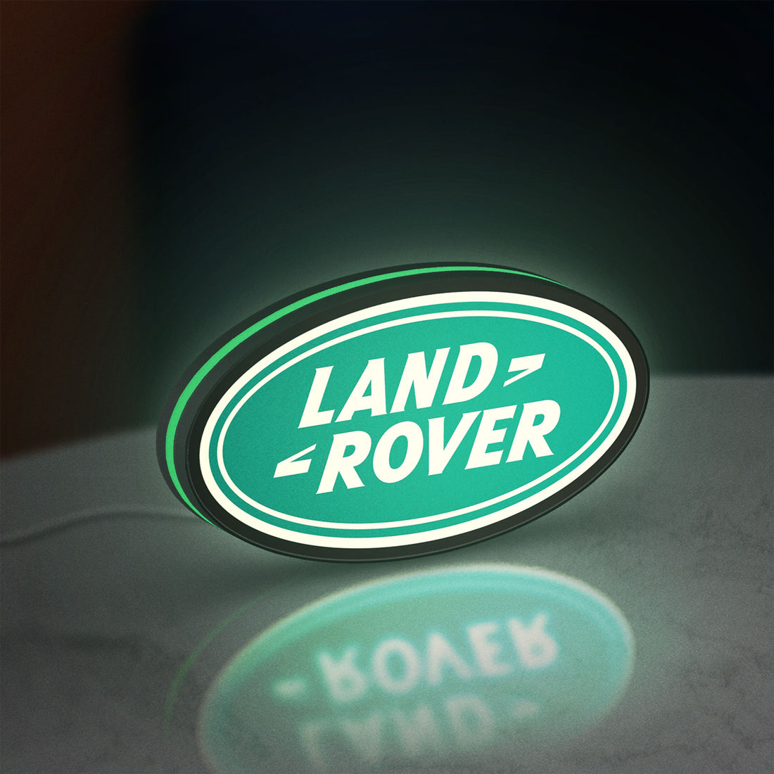 Land Rover LED lightbox hanging on a wall with green glow