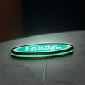 Land Rover LED lightbox lying flat on a desk with green glow