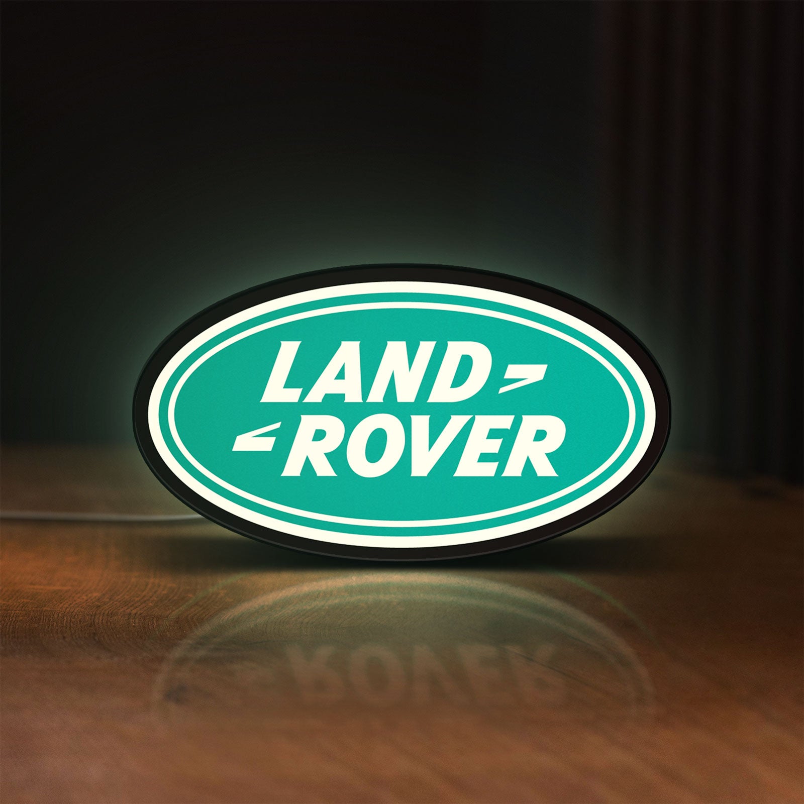 Front view of Land Rover LED lightbox sign glowing on a wooden desk