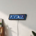 Unlit Fiat LED lightbox mounted on a wall in daylight