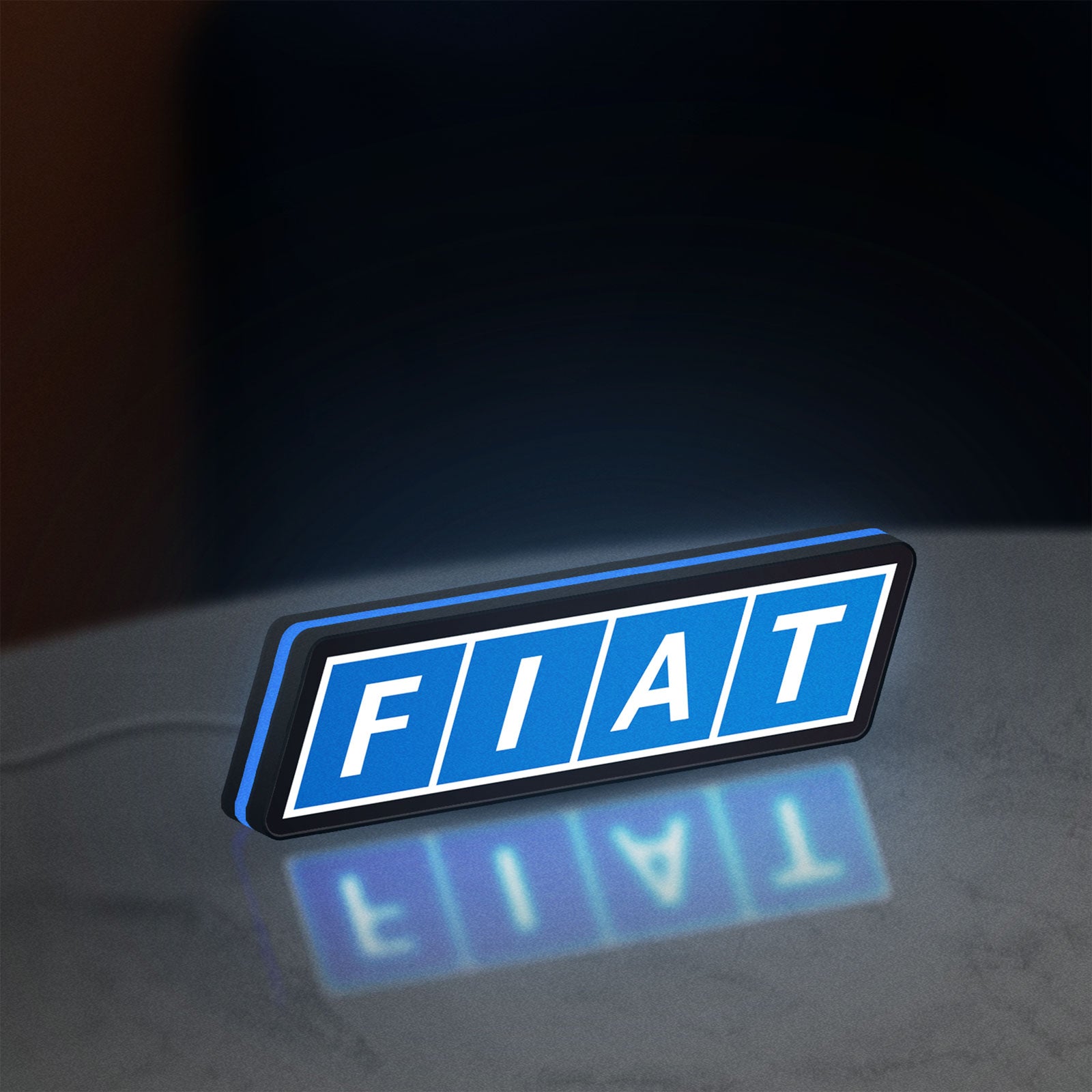 Fiat LED lightbox standing on a desk from an angled side view with blue glow