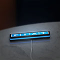 Fiat LED lightbox lying flat on a desk with blue glow