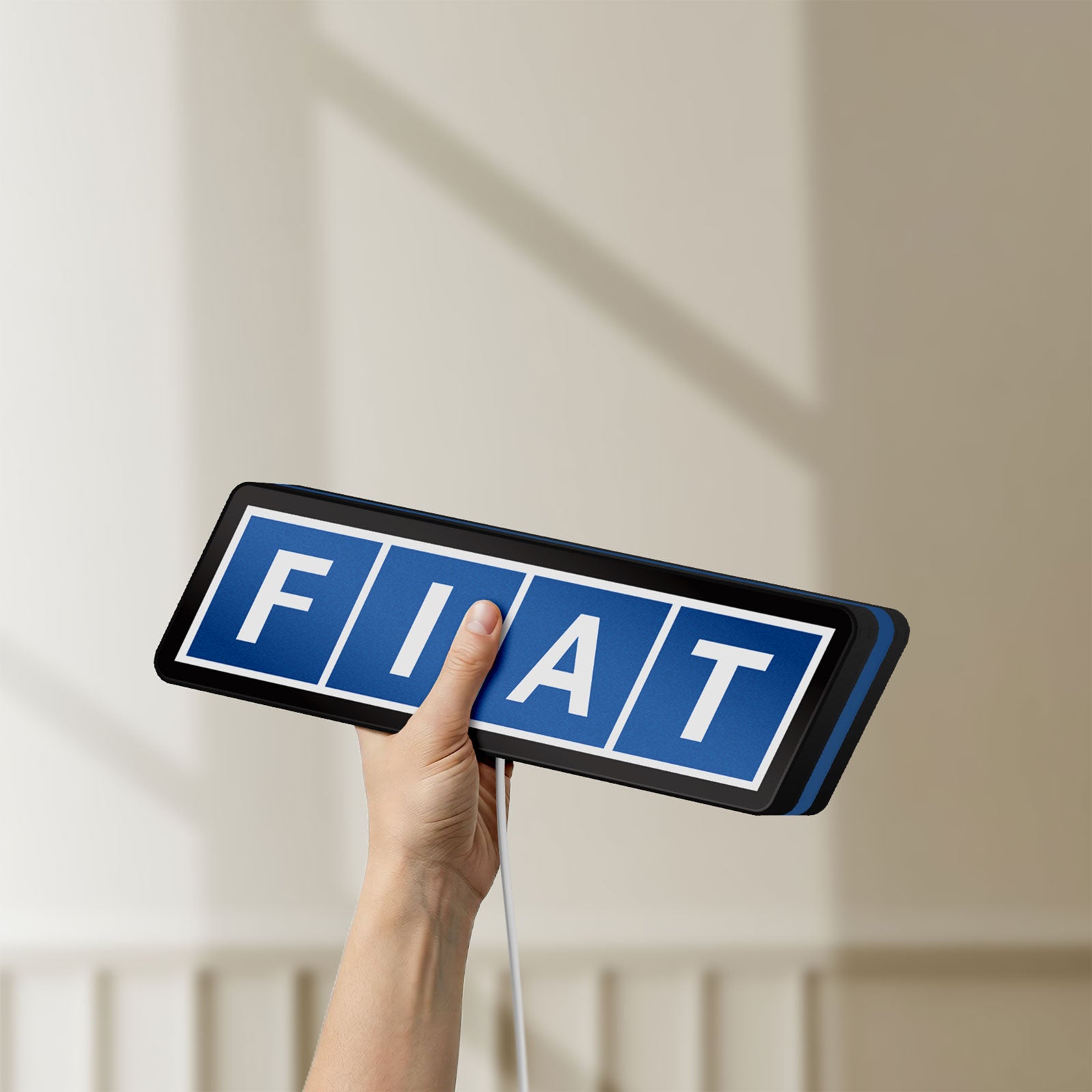 Unlit Fiat LED lightbox held by hand to show size and details