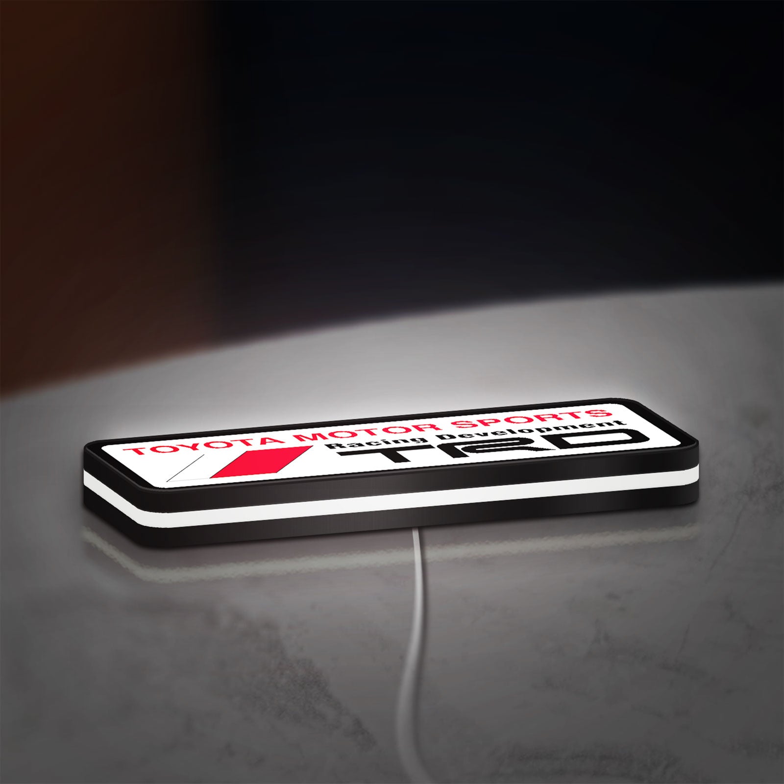 TRD LED lightbox lying flat on a desk with white glow